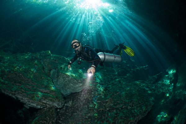 Underwater stills photographer capturing a cave diver